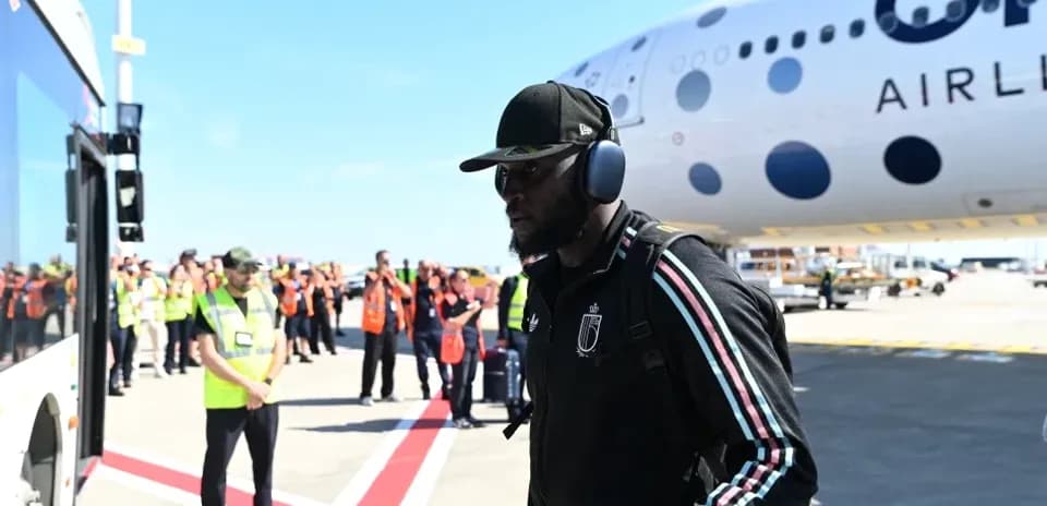 Player arriving at airport next to airplane