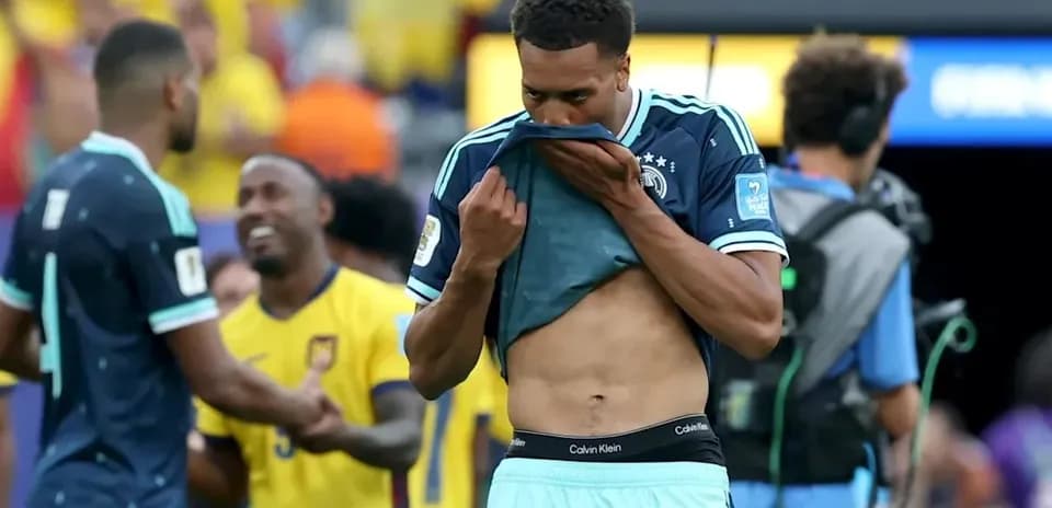 Player removing shirt after match with disappointment