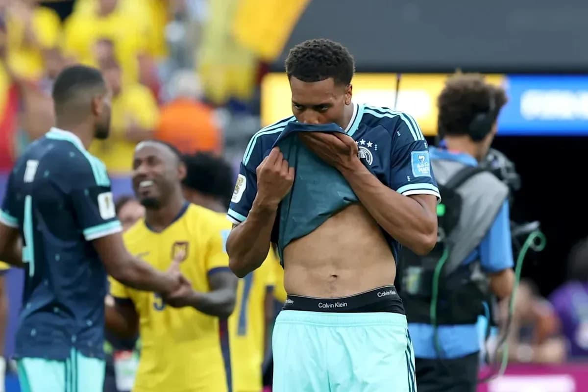Player removing shirt after match with disappointment