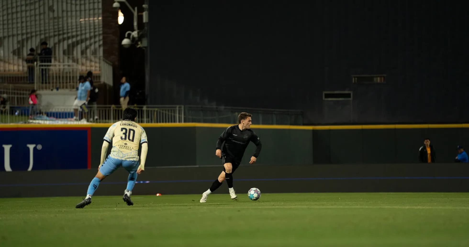 Players competing for the ball in USL match