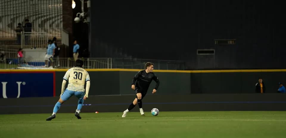 Players competing for the ball in USL match