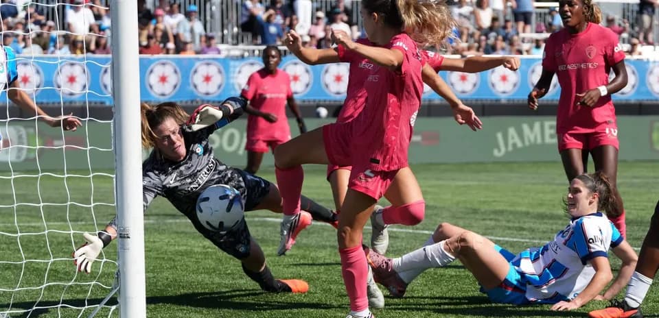 Goalkeeper diving to save shot during match