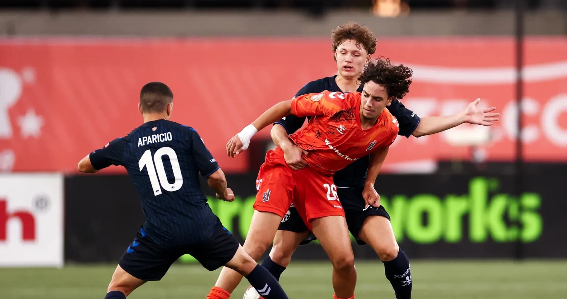 Players competing for the ball in football match