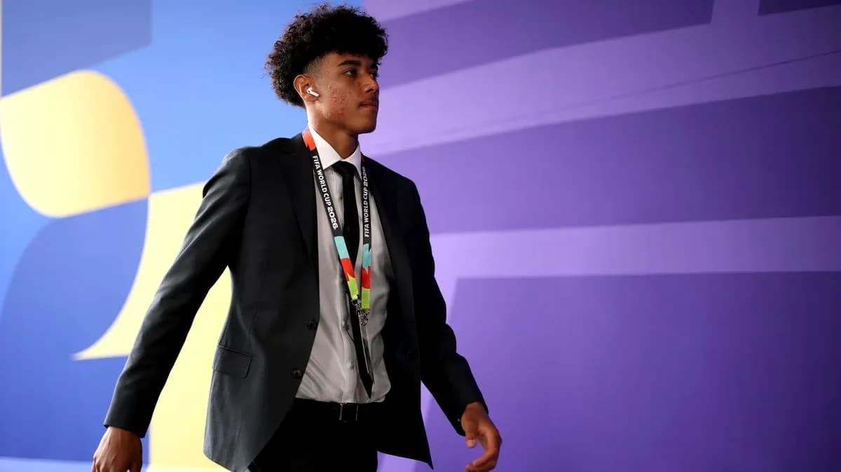 Player in suit walking with FIFA World Cup pass