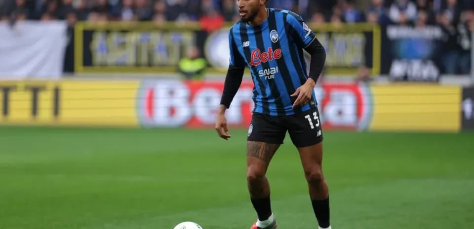 Player in Atalanta kit preparing for action on field