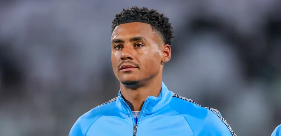 Player in blue training jacket on the field