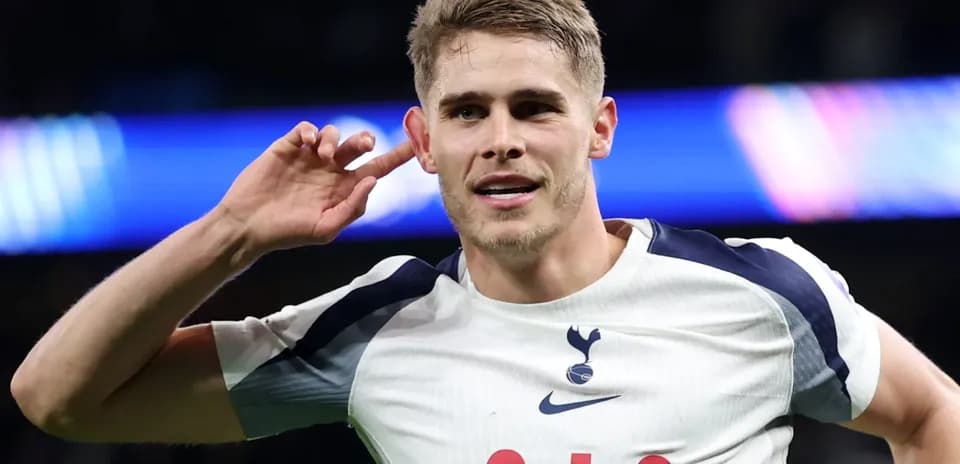 Player celebrating a goal with hand to ear