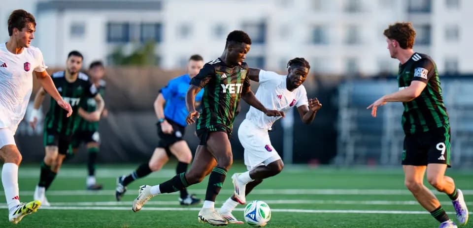Players competing for the ball in MLS Next Pro match