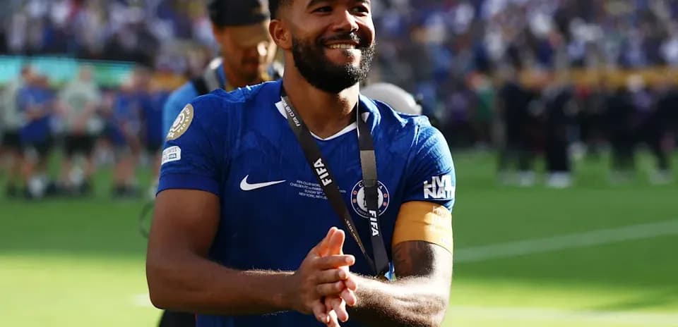 Player celebrating with medal on the field