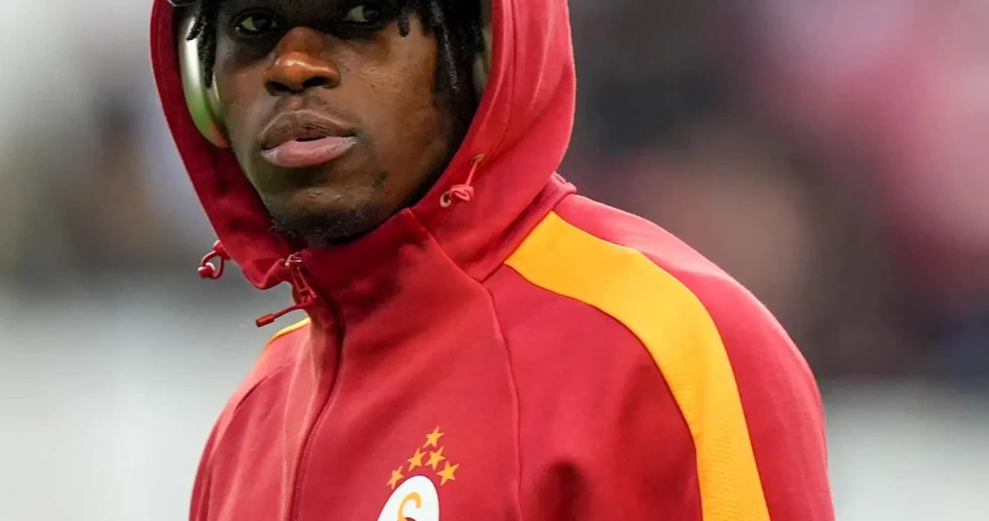 Player in Galatasaray hoodie during match warm-up