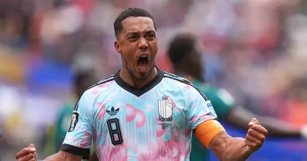 Player celebrating with raised fists in colorful jersey