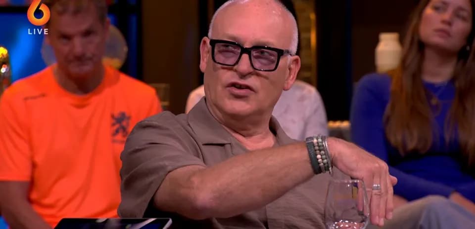 Man speaking during a talk show with audience