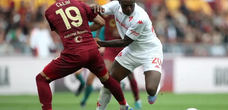 Çelik tackling player during AS Roma match
