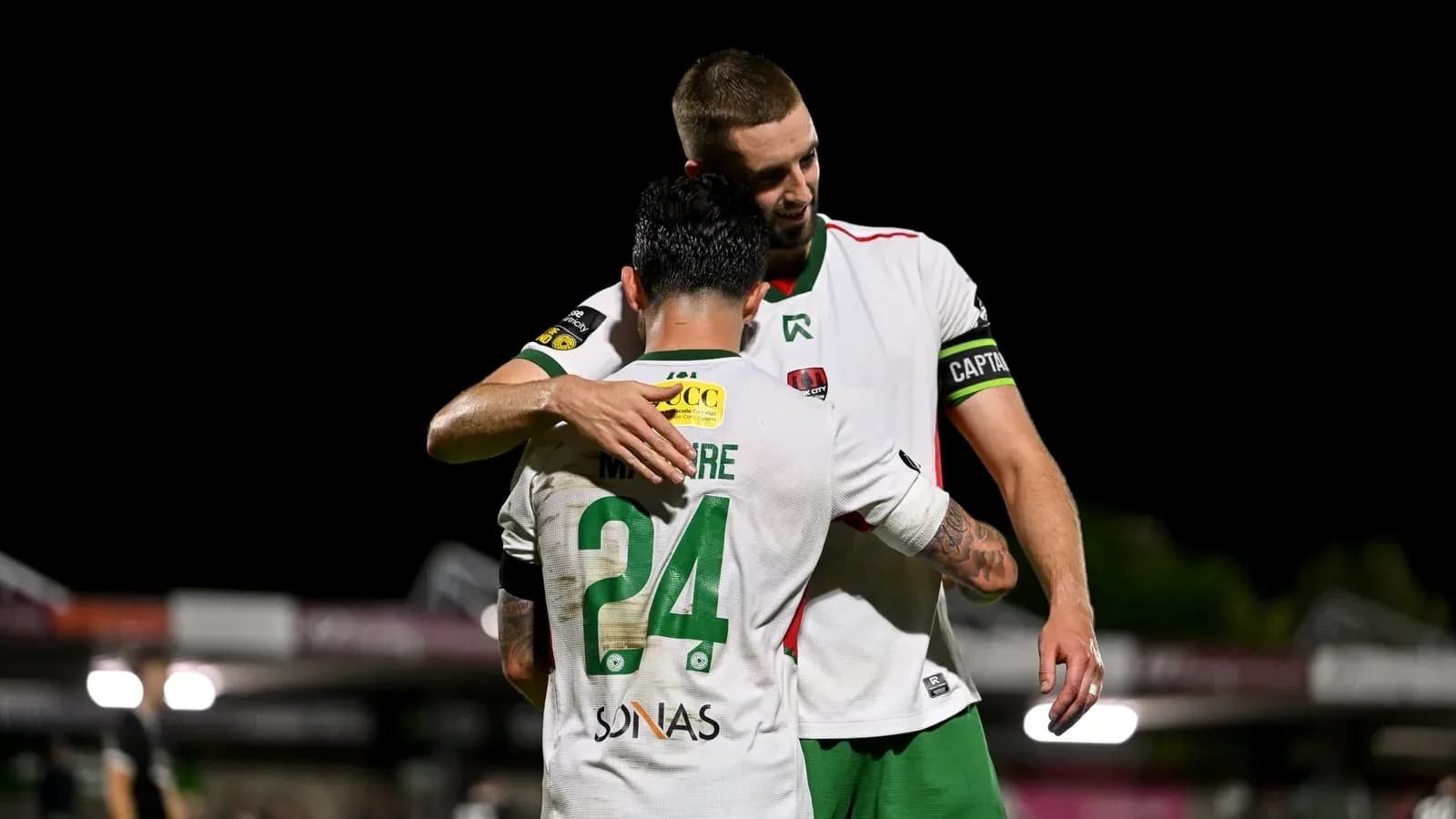 Players embracing after a match on the field