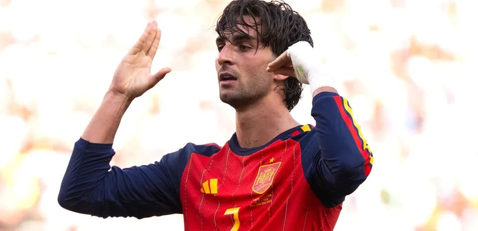 Player signaling during a football match wearing Spain jersey