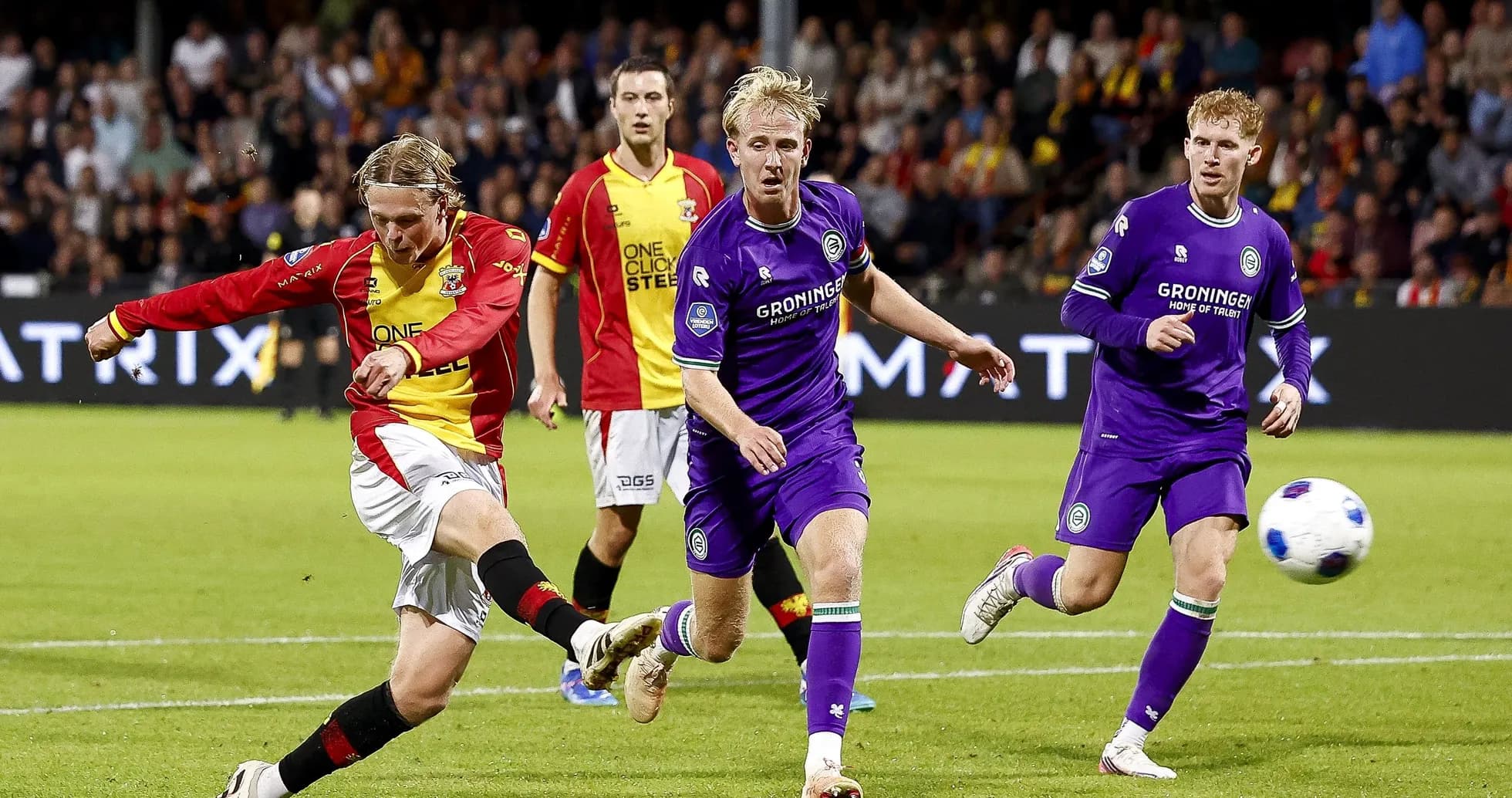 Player shooting the ball during a football match