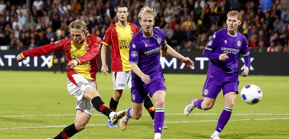 Player shooting the ball during a football match