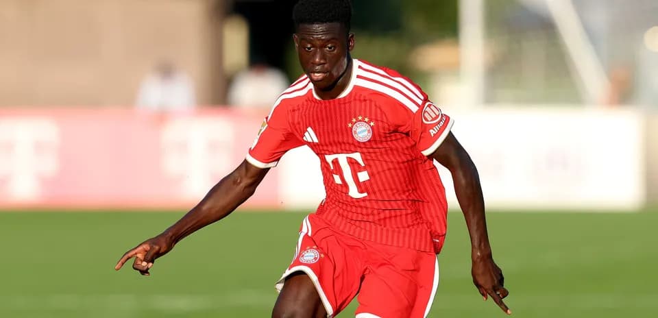 Player in red Bayern Munich kit running on field