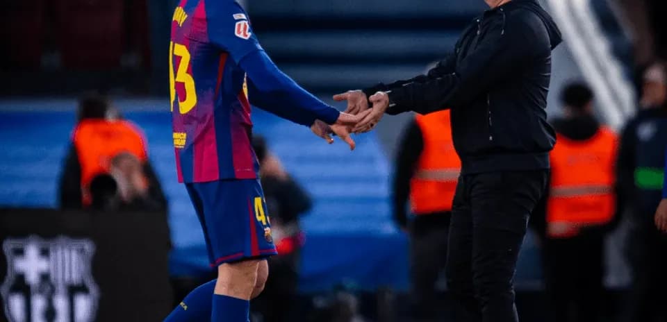 Player and coach shaking hands on the field