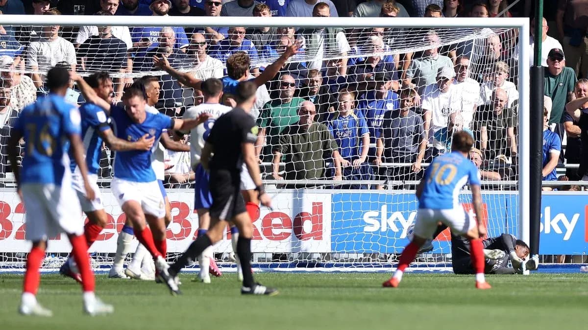 Players reacting during a goal attempt in football match