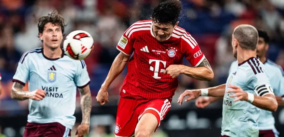 Bayern player heading the ball during match action