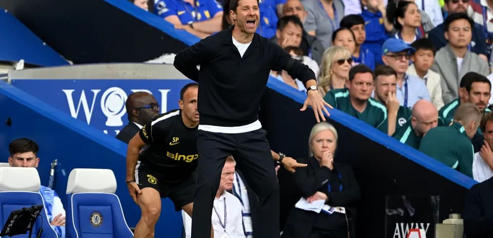 Coach gesturing passionately on the sidelines