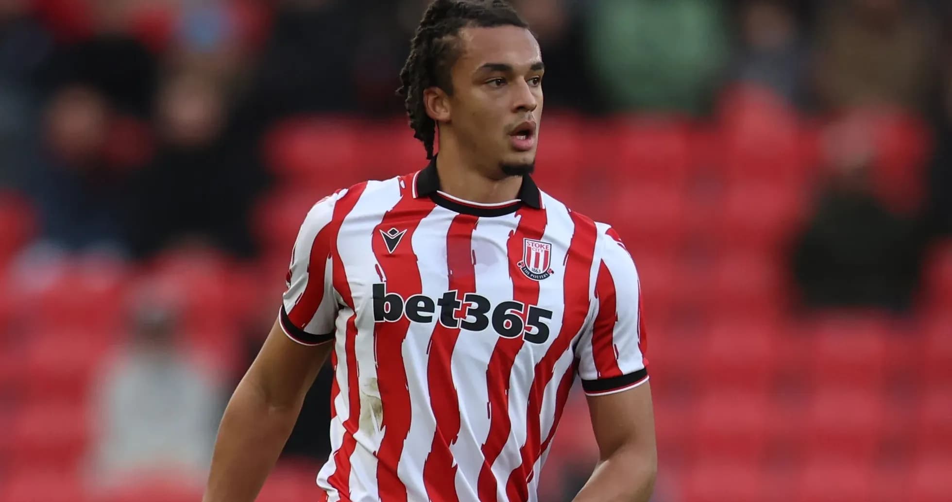 Stoke City player in red and white striped jersey