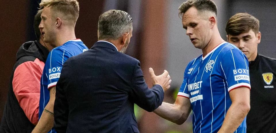 Rangers players interacting with manager during substitution
