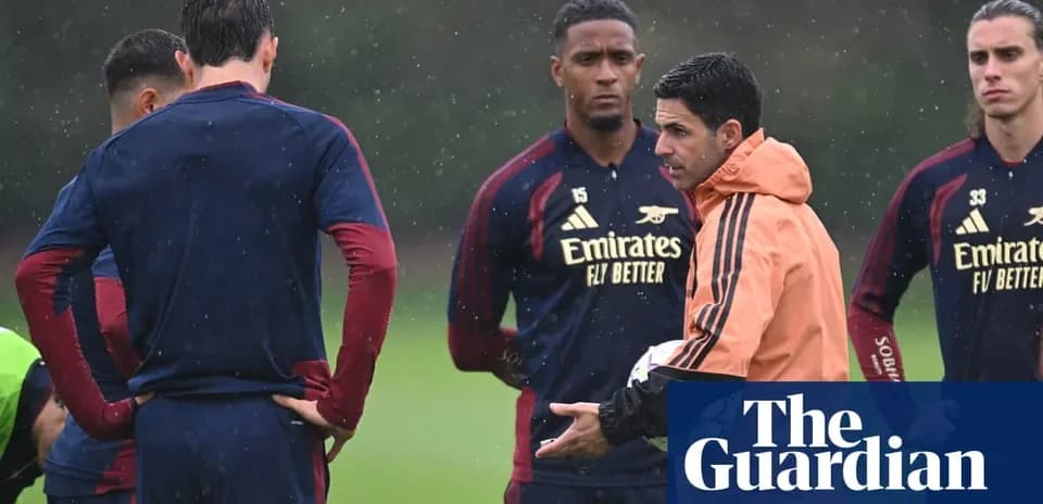 Arsenal manager discussing strategy with players during training
