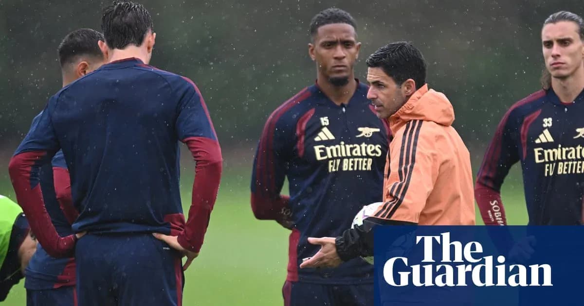 Arsenal manager discussing strategy with players during training