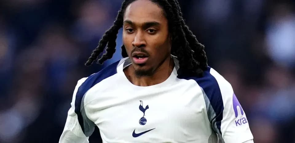 Player running in Tottenham Hotspur jersey during match