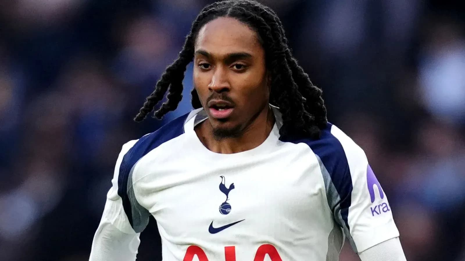 Player running in Tottenham Hotspur jersey during match