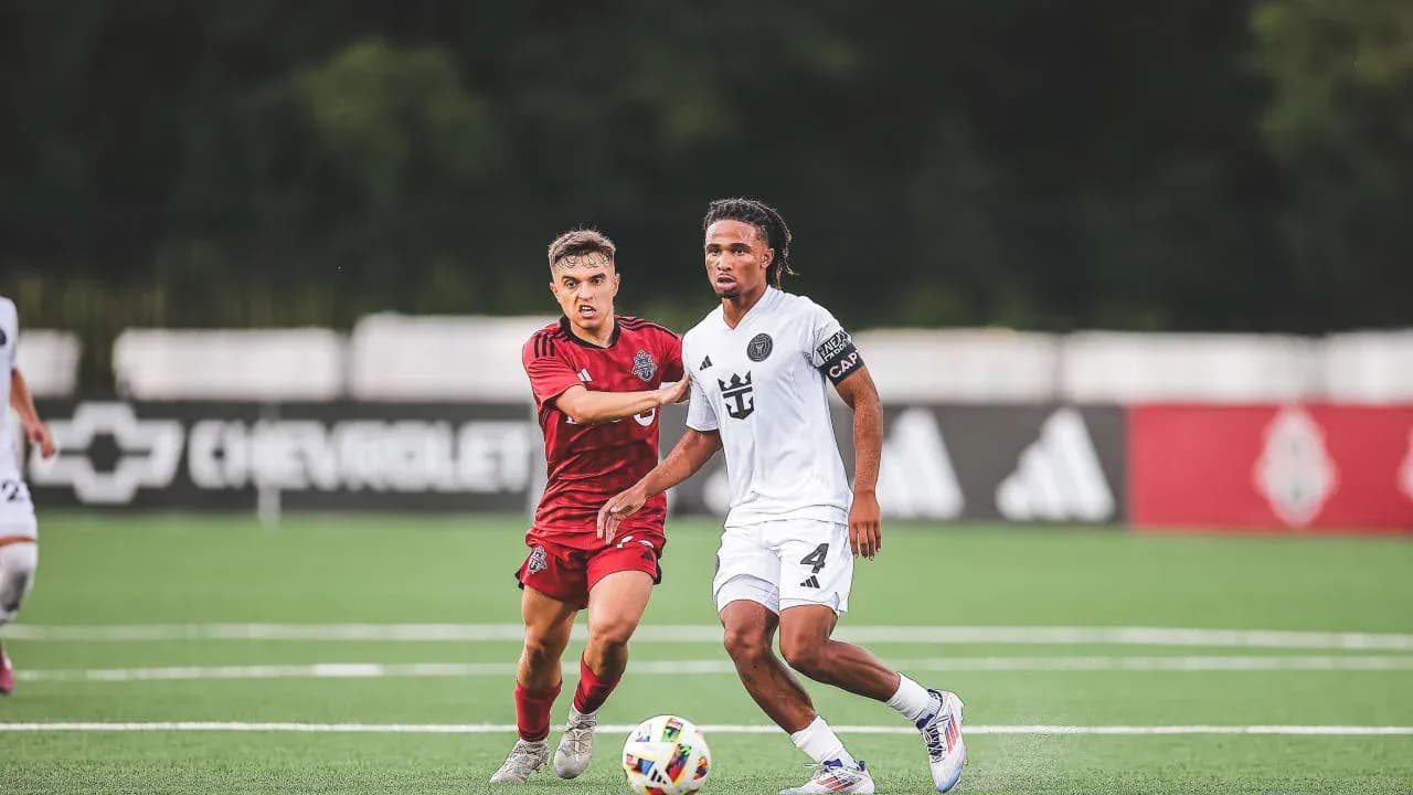 Player dribbling while being challenged by opponent