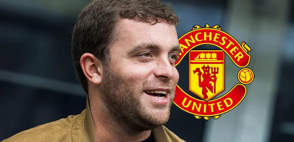 Man smiling with Manchester United logo in background