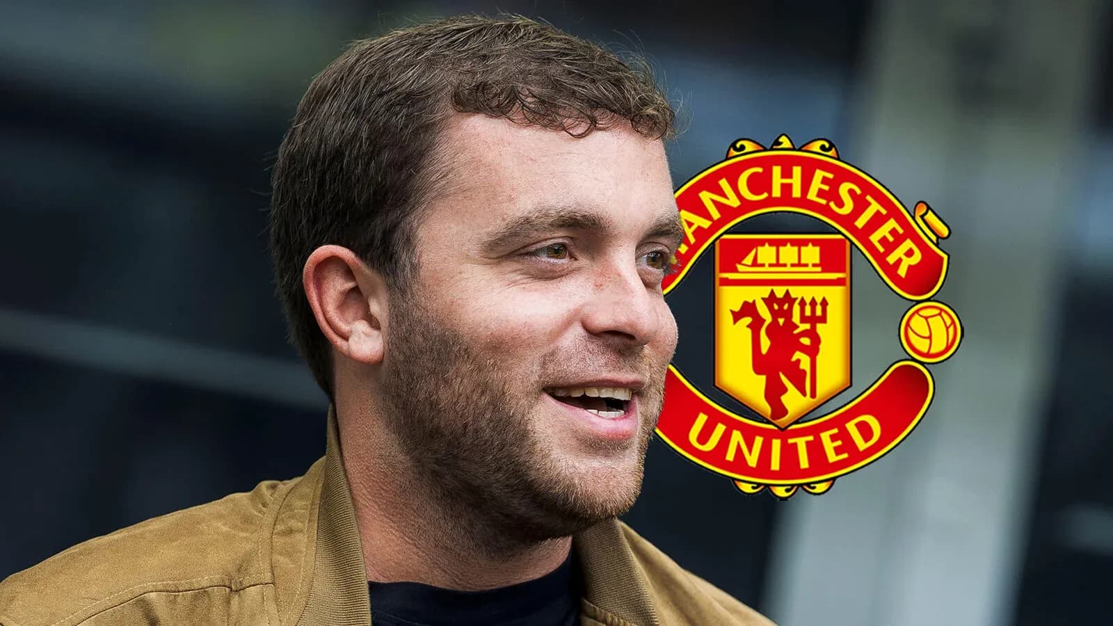 Man smiling with Manchester United logo in background