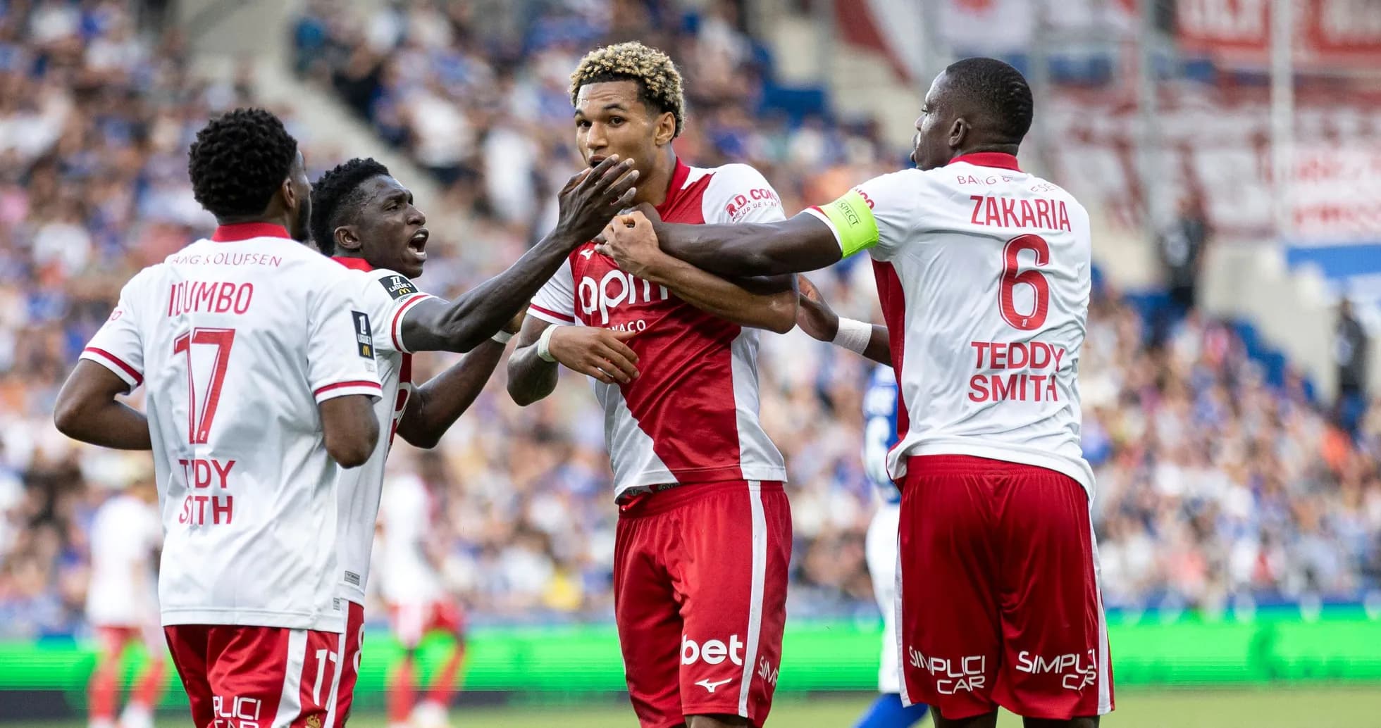 Players celebrating a goal on the field