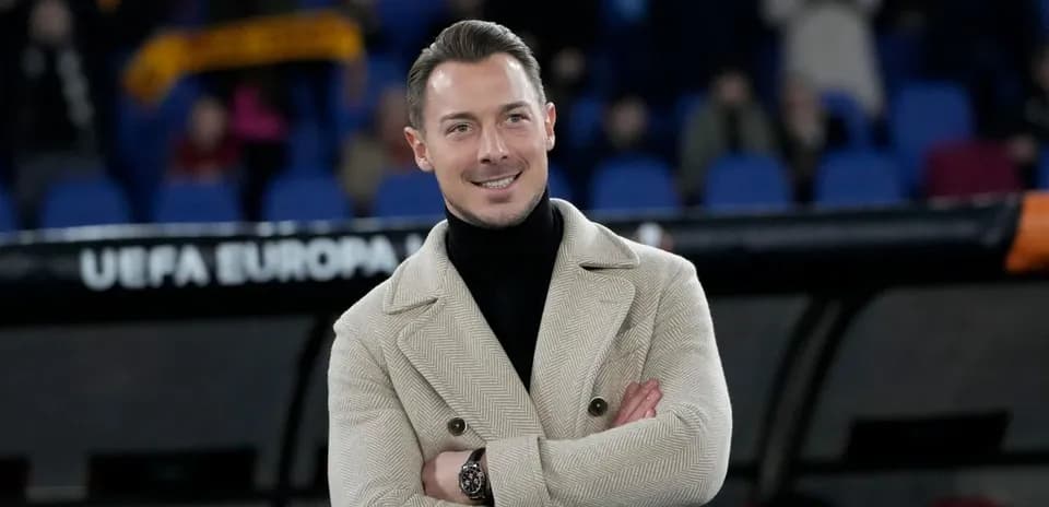 Man in stylish coat standing on the sidelines
