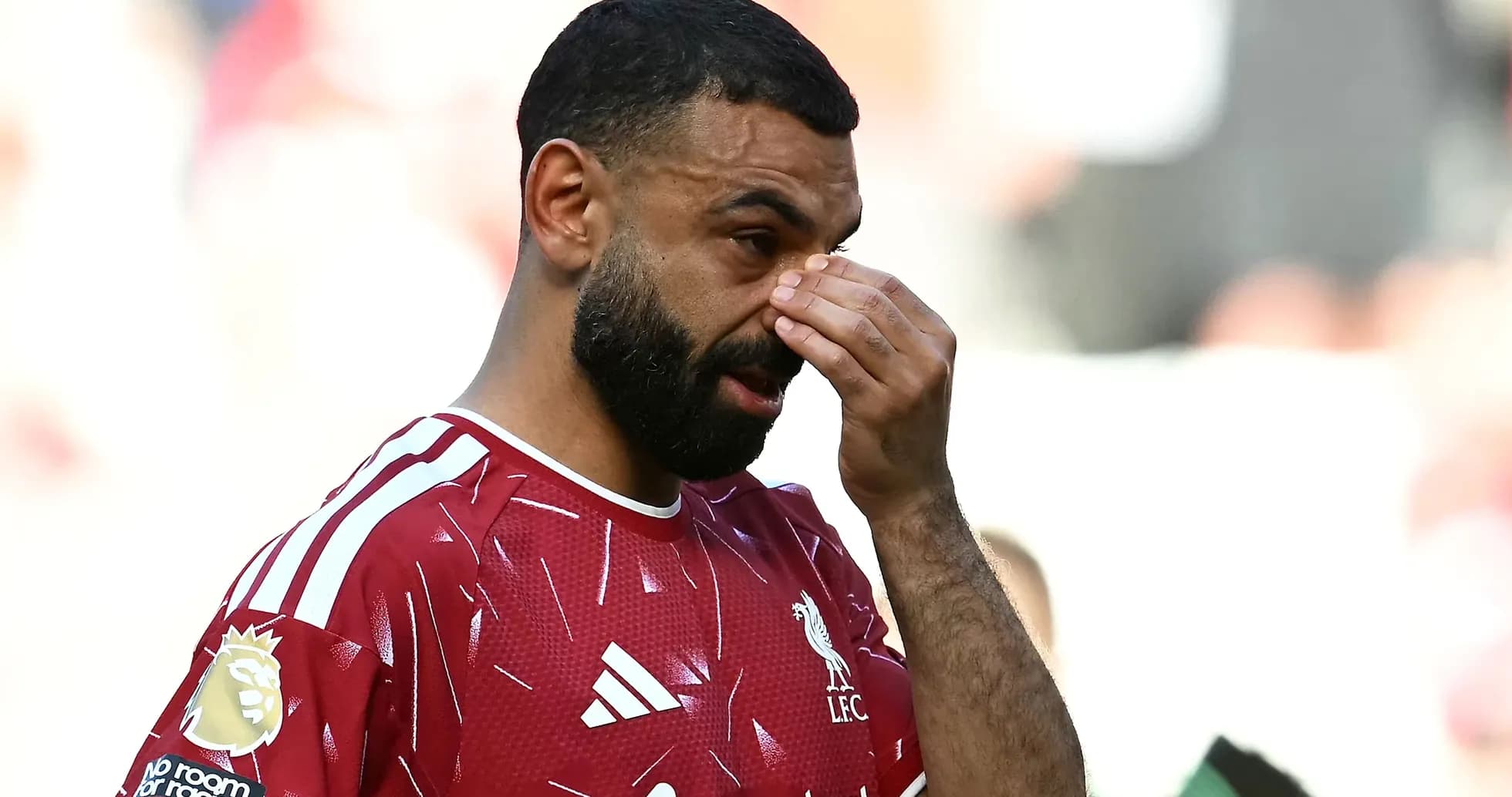 Player wiping forehead during match on field