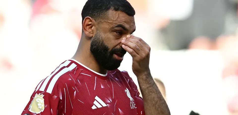Player wiping forehead during match on field