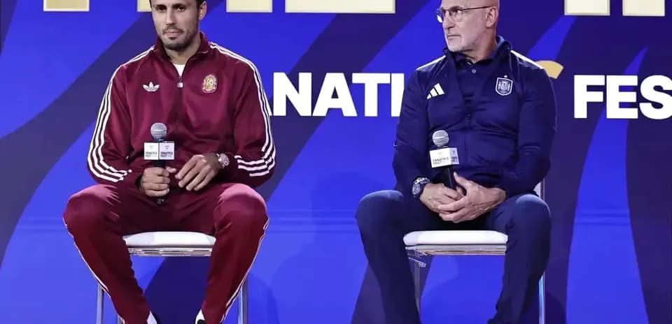 Two coaches seated at a press conference