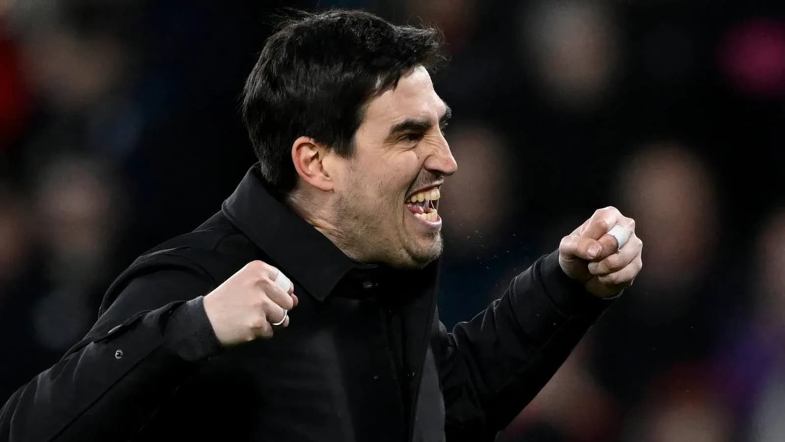 Coach celebrating a goal with clenched fists