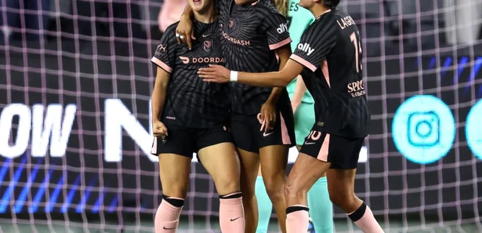 Players celebrating during NWSL match