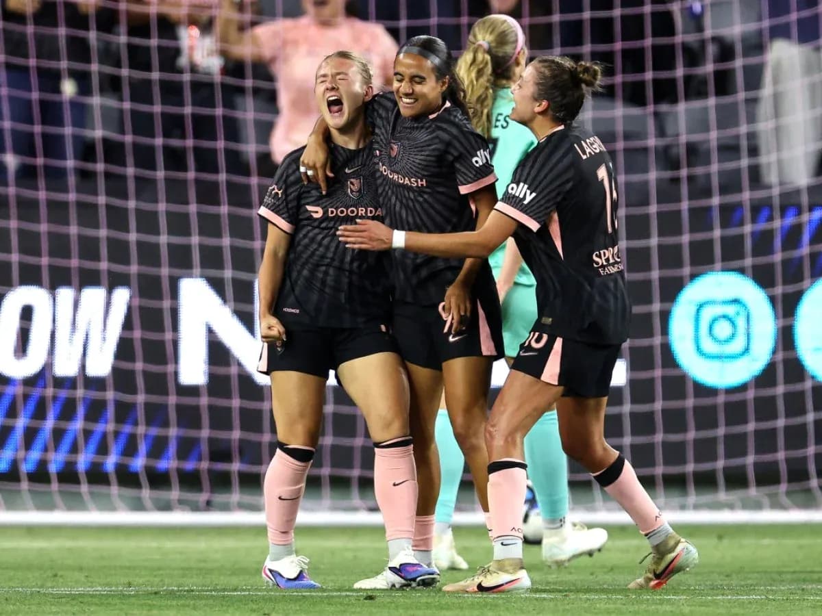 Players celebrating during NWSL match