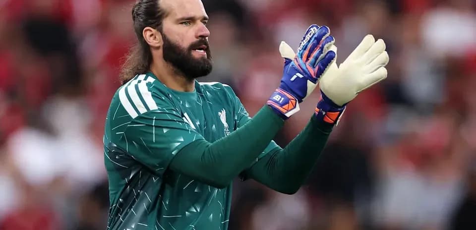 Goalkeeper in green jersey preparing for action