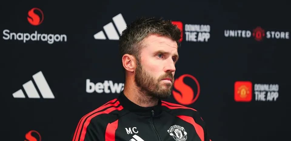 Manager at press conference with Manchester United branding