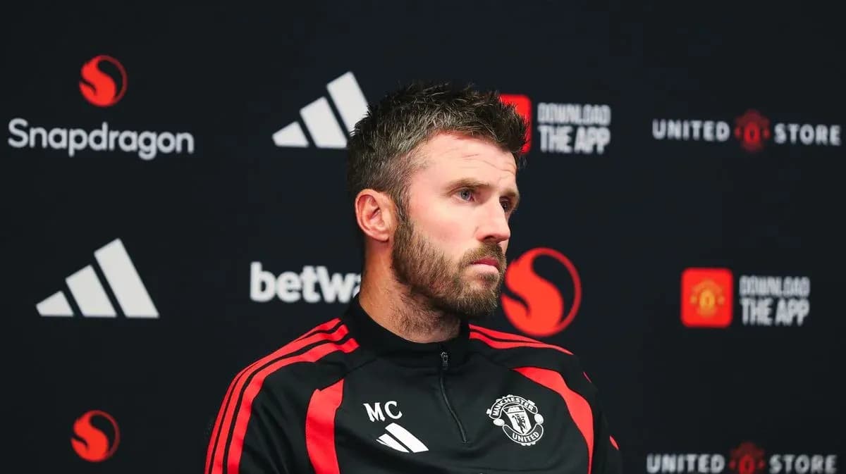 Manager at press conference with Manchester United branding