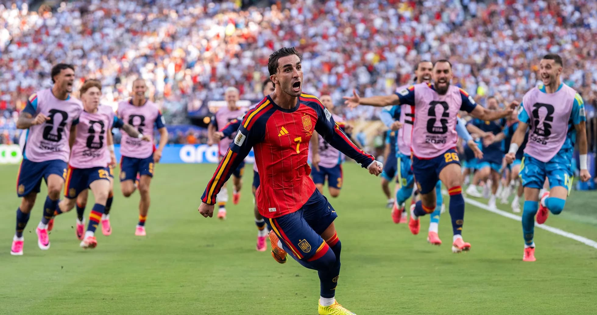 Spanish player celebrating a goal with teammates