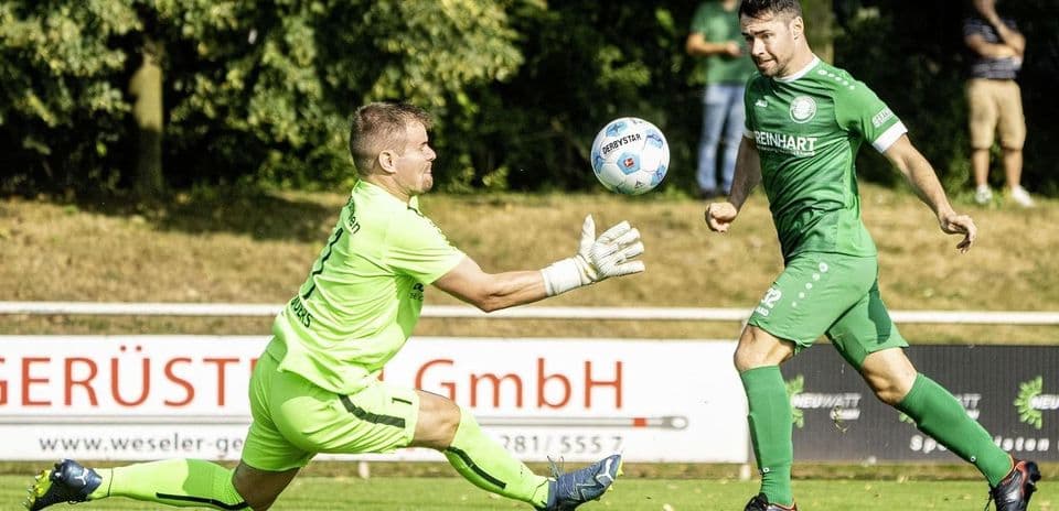 Goalkeeper saving the ball during football match