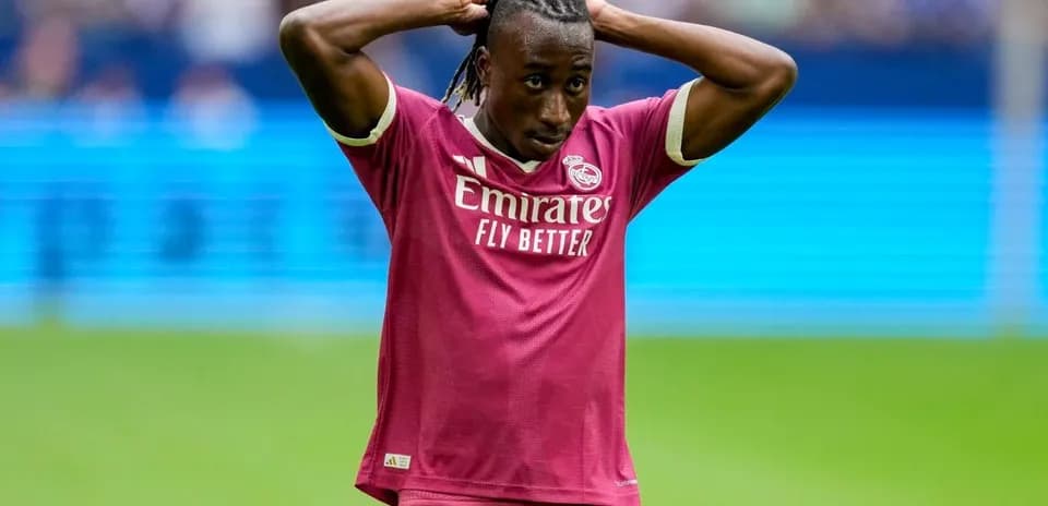 Player in pink Real Madrid kit with hands on head