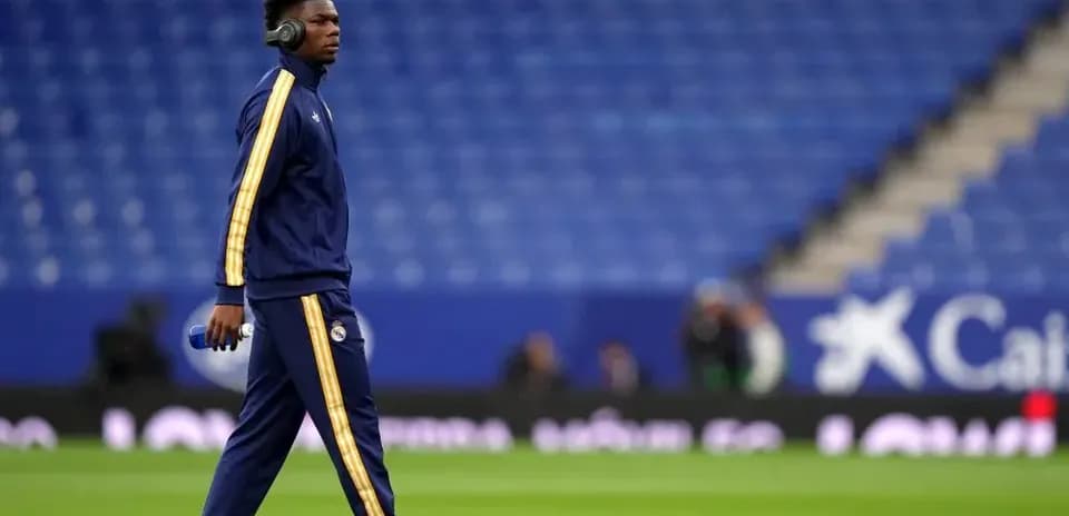 Player walking on pitch in warm-up attire